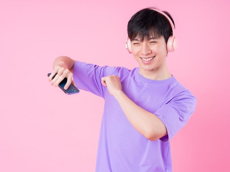 Chinese guy listening to music app and dancing