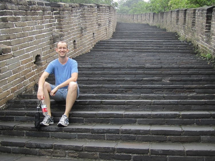 Tourist on steps of Great Wall Beijing