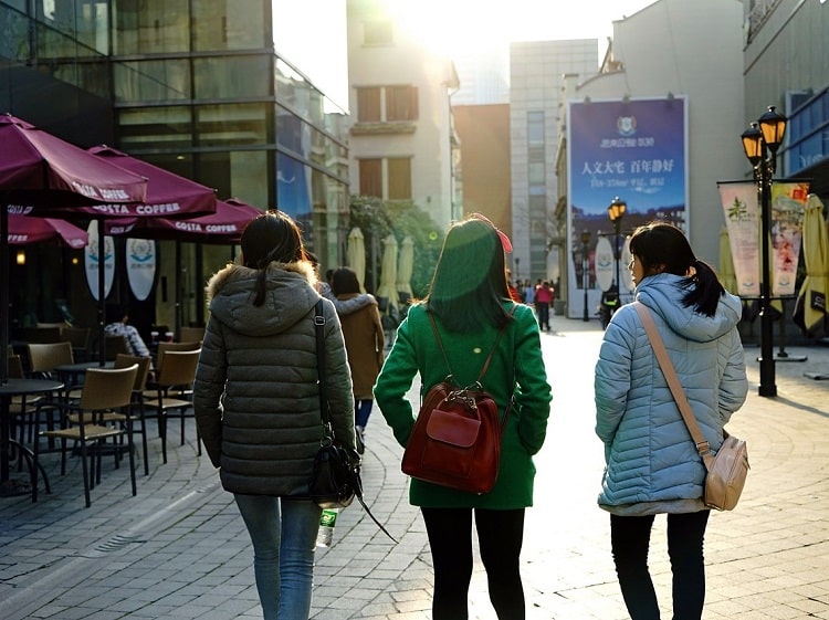 Chinese girls on a street walking away