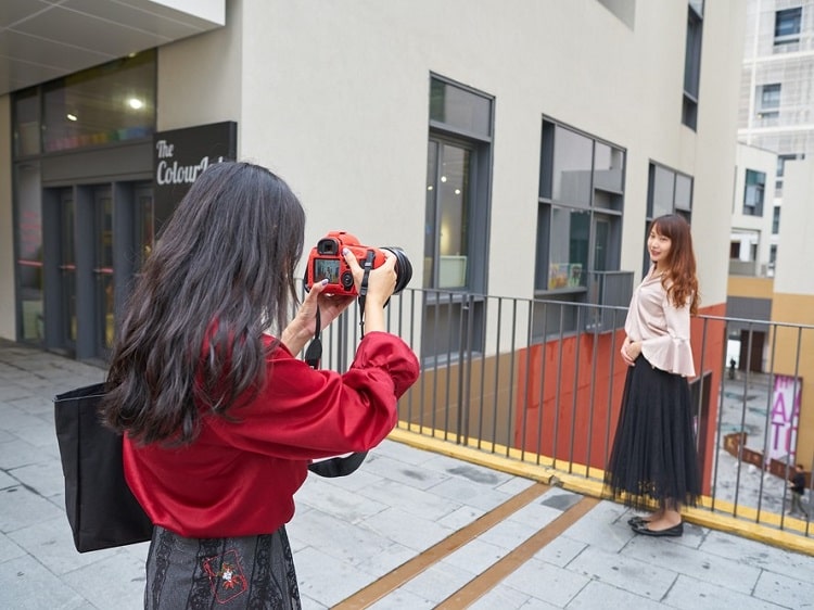 Chinese woman taking photo of another woman