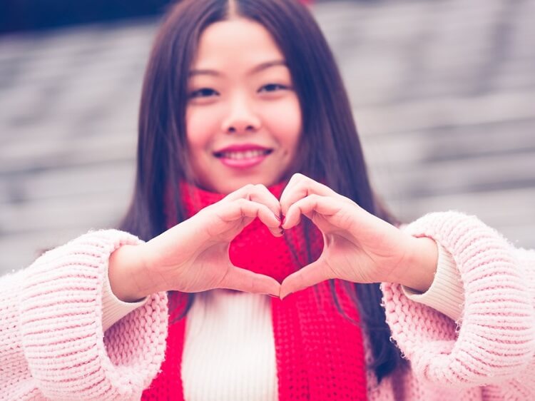 Chinese girl making a heart symbol