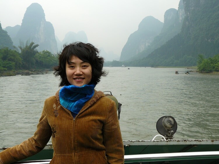 Smiling Chinese woman on boat