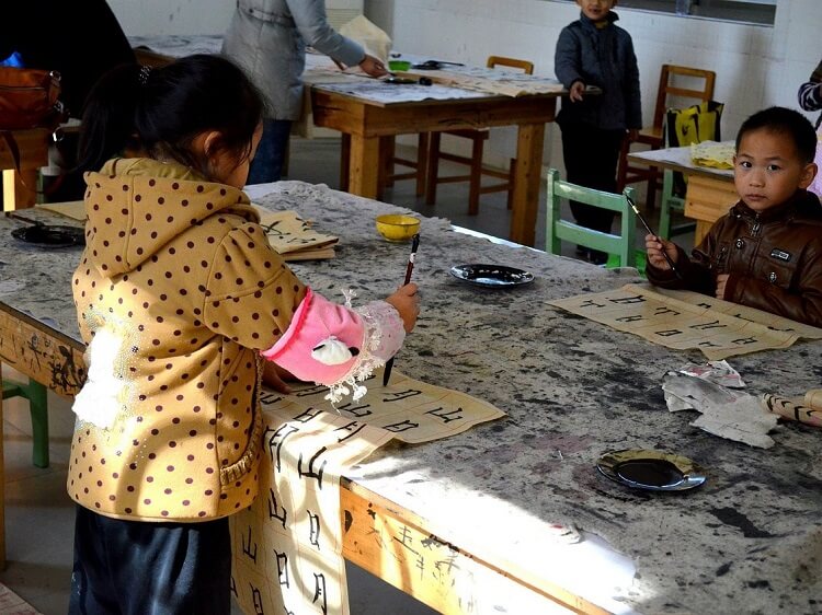Chinese kids doing calligraphy