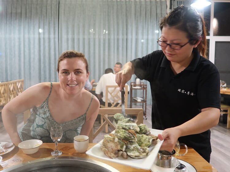 Foreign woman being served food in China