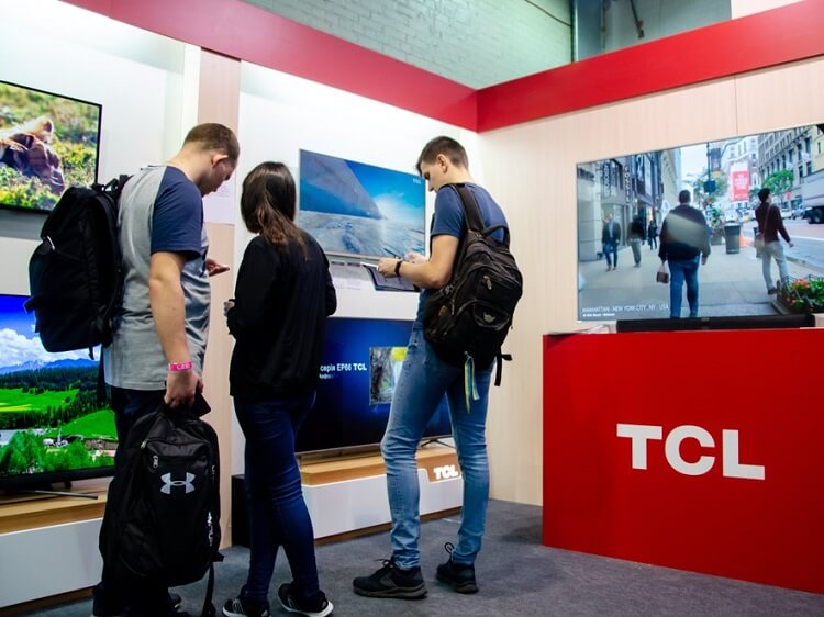People looking at TCL smart TV