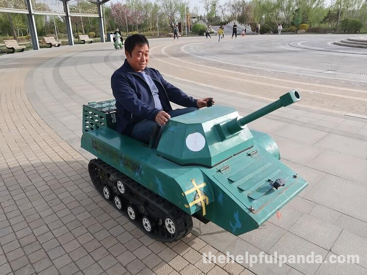 funny chinese photo - man sitting in children's tank