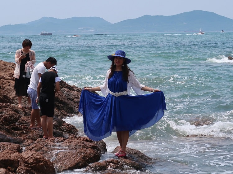 chinese woman dressed at the beach