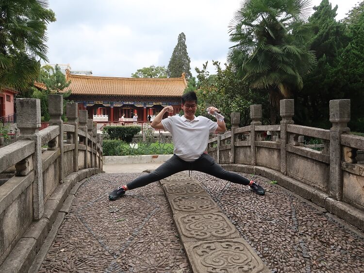 tourist stretching in front of confucian temple
