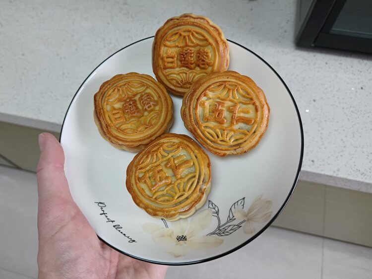 four traditional moon cakes on a plate