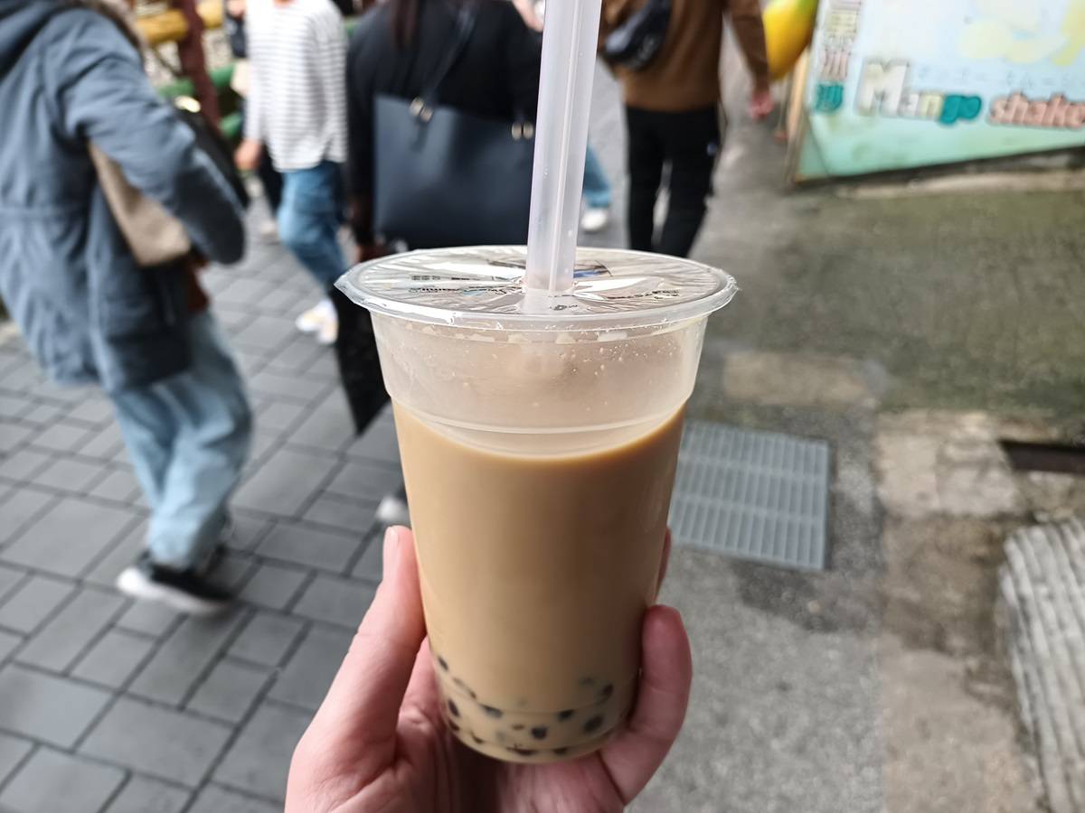 cup of pearl milk bubble tea with straw